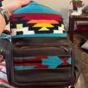 American Darling, backpack, has a little tear on the top as shown.